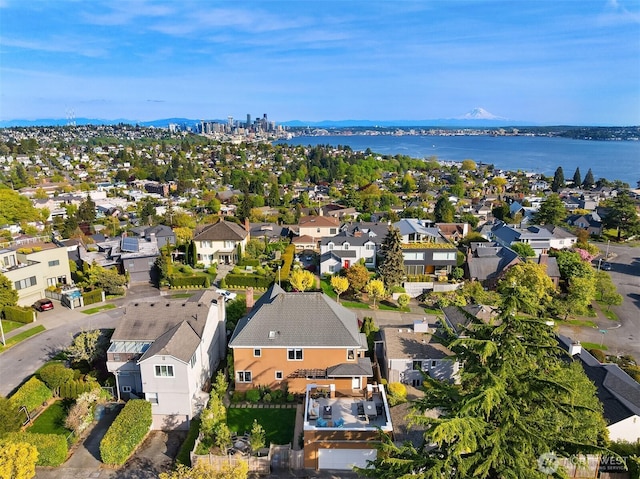 birds eye view of property featuring a residential view and a water and mountain view