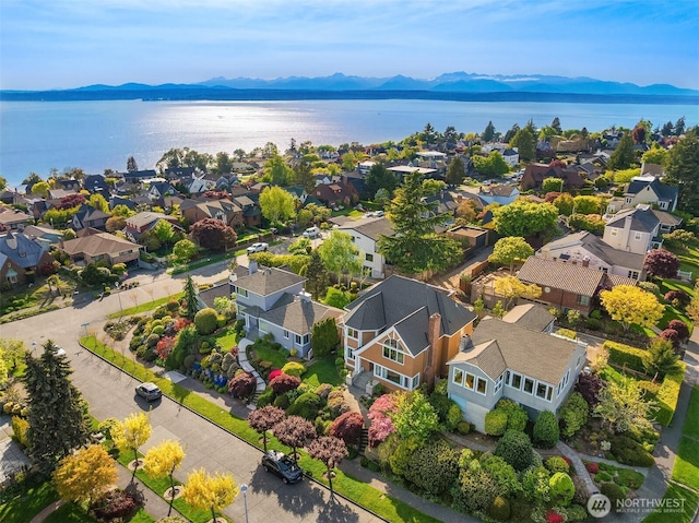 birds eye view of property with a water and mountain view and a residential view
