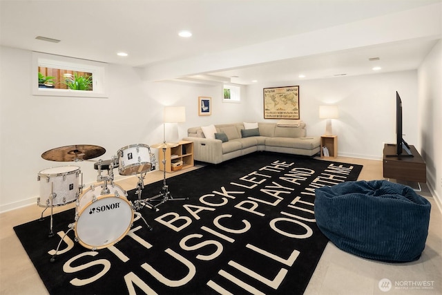 living area featuring recessed lighting and baseboards