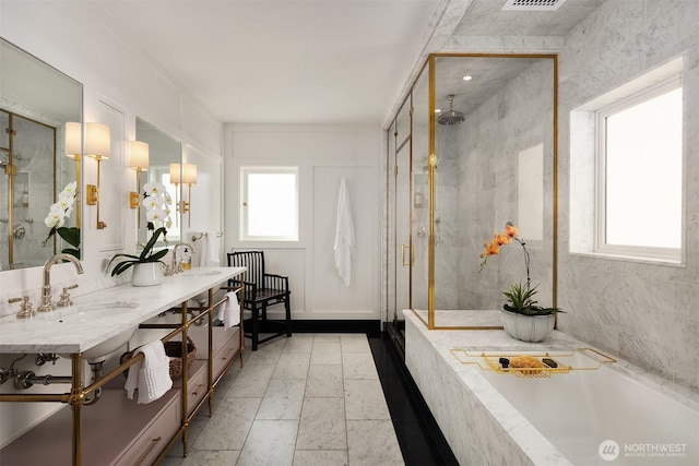 full bathroom featuring a sink, a bathing tub, plenty of natural light, and a stall shower