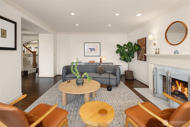 living room featuring stairs, recessed lighting, baseboards, wood finished floors, and a high end fireplace