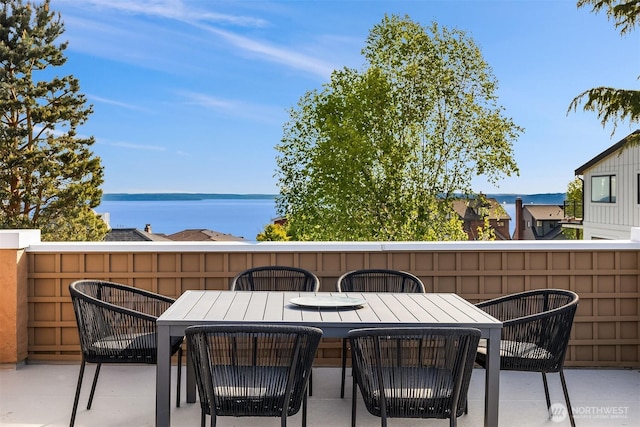 view of patio / terrace featuring outdoor dining space and a water view