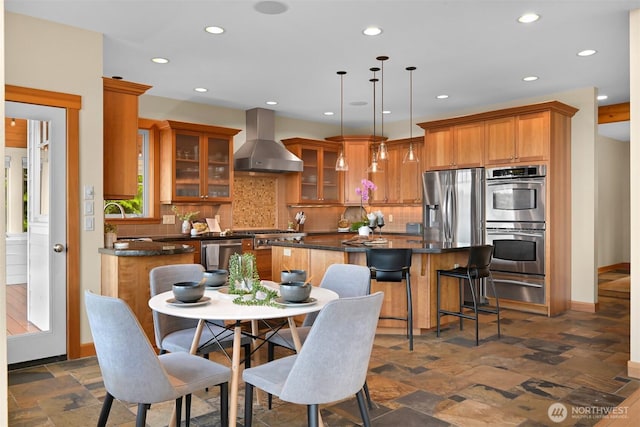 dining area with recessed lighting, stone finish flooring, and baseboards