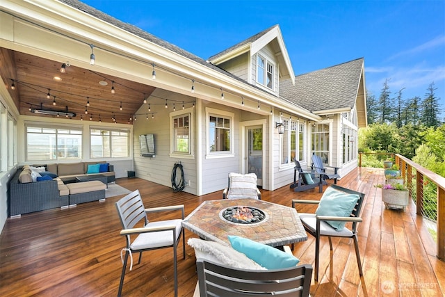 deck featuring an outdoor living space with a fire pit