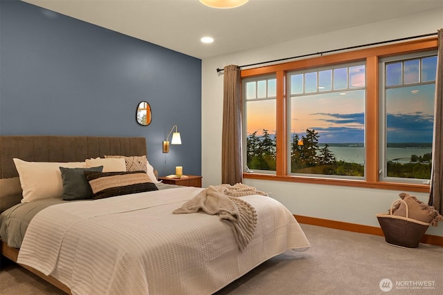 bedroom with carpet flooring, a water view, baseboards, and recessed lighting
