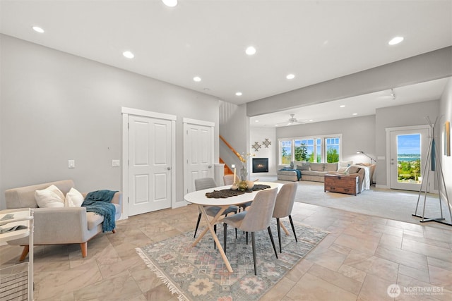 dining room featuring stairway, recessed lighting, and stone tile floors