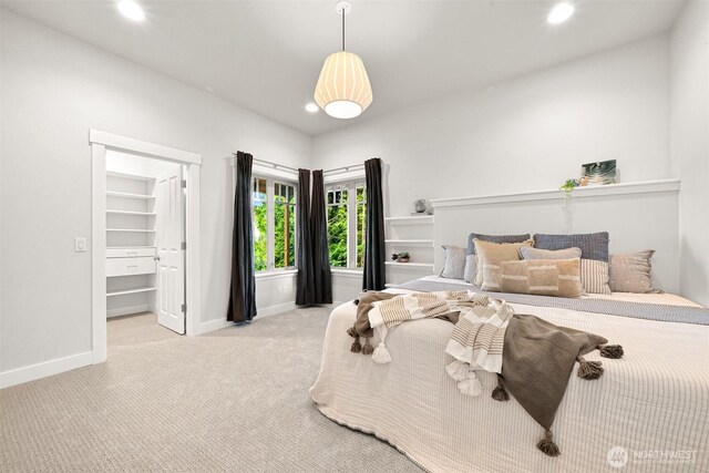 carpeted bedroom with baseboards, recessed lighting, and a walk in closet