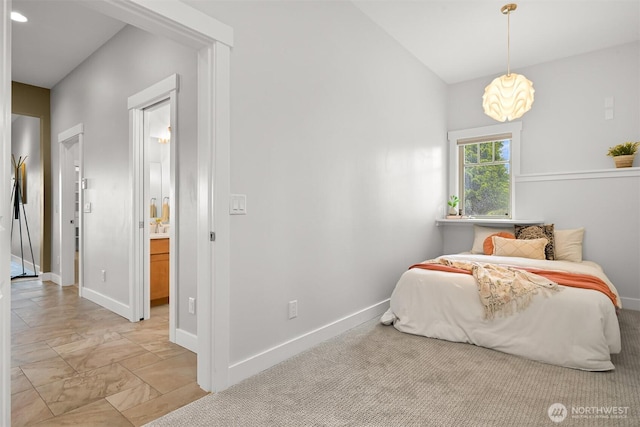 bedroom featuring baseboards, connected bathroom, and marble finish floor