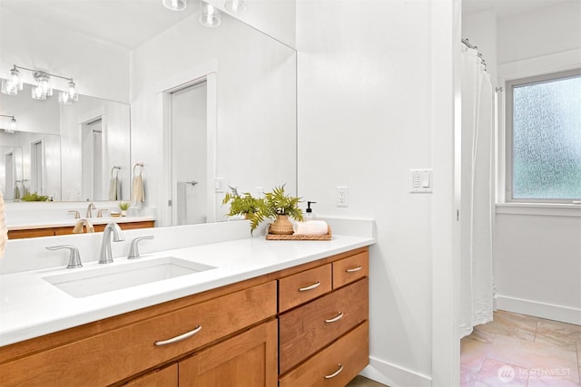bathroom featuring baseboards and vanity