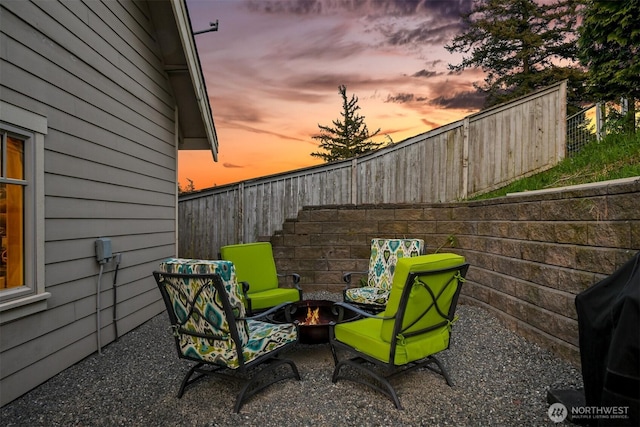 patio terrace at dusk with fence and a fire pit