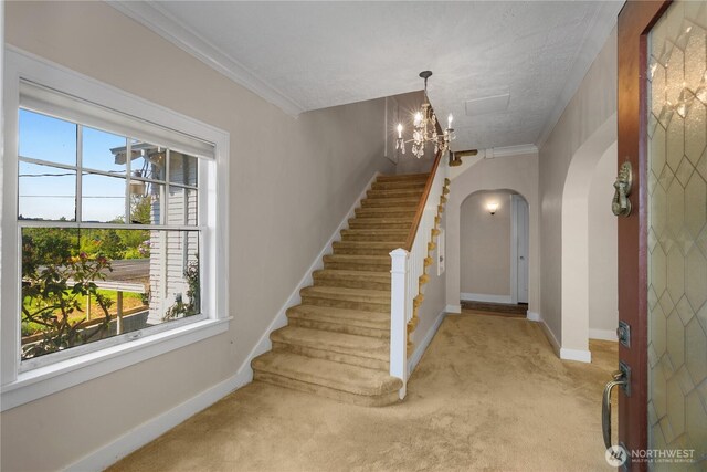 437 NW Pennsylvania Ave, Chehalis, WA 98532 - entrance foyer featuring an inviting chandelier, carpet floors, arched walkways, stairs, and baseboards