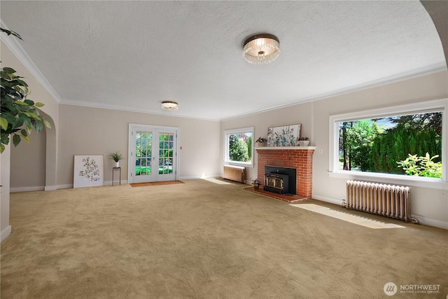 437 NW Pennsylvania Ave, Chehalis, WA 98532 - unfurnished living room with french doors, a textured ceiling, crown molding, radiator heating unit, and carpet flooring