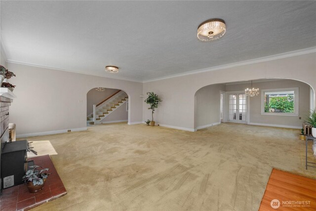 437 NW Pennsylvania Ave, Chehalis, WA 98532 - unfurnished living room with arched walkways, ornamental molding, and carpet