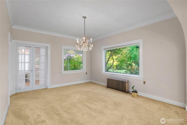 437 NW Pennsylvania Ave, Chehalis, WA 98532 - carpeted spare room featuring a notable chandelier, ornamental molding, and radiator heating unit
