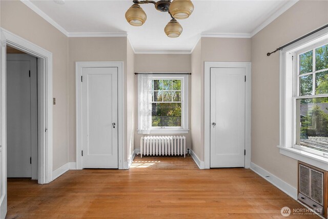 437 NW Pennsylvania Ave, Chehalis, WA 98532 - doorway with light wood-style floors, radiator, crown molding, and a healthy amount of sunlight