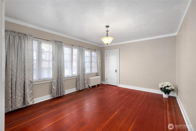 437 NW Pennsylvania Ave, Chehalis, WA 98532 - spare room with radiator heating unit, baseboards, ornamental molding, and wood-type flooring