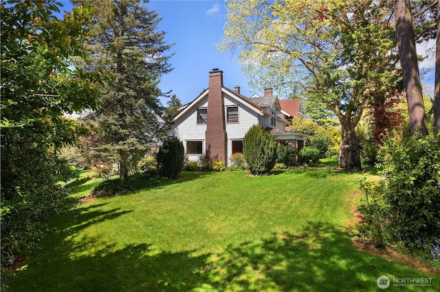 437 NW Pennsylvania Ave, Chehalis, WA 98532 - view of side of home with a lawn and a chimney