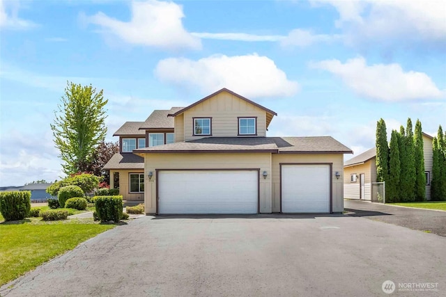 300 Range View Rd, Ellensburg, WA 98926 - view of front facade featuring board and batten siding, asphalt driveway, an attached garage, and a front lawn