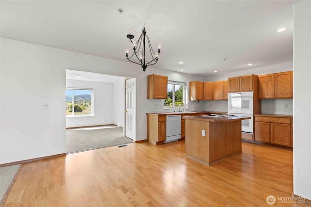 300 Range View Rd, Ellensburg, WA 98926 - kitchen with white appliances, light wood-style floors, a center island, a chandelier, and recessed lighting