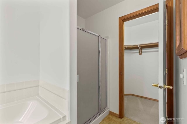 300 Range View Rd, Ellensburg, WA 98926 - full bathroom featuring a shower stall, a garden tub, a walk in closet, and baseboards