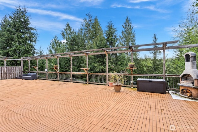 view of patio / terrace featuring exterior fireplace, a pergola, and a deck