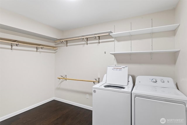 laundry room with baseboards, laundry area, dark wood finished floors, and washer and clothes dryer