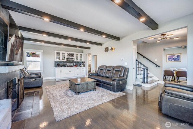 3012 N 30th St, Tacoma, WA 98407 - living area featuring a tile fireplace, baseboards, beamed ceiling, dark wood-style floors, and stairs