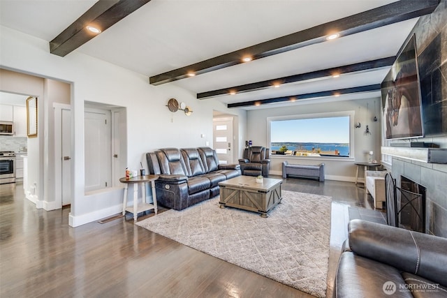 3012 N 30th St, Tacoma, WA 98407 - living area with a tiled fireplace, baseboards, dark wood-style flooring, and beam ceiling