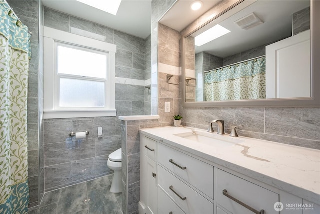 3012 N 30th St, Tacoma, WA 98407 - bathroom featuring vanity, visible vents, toilet, tile walls, and a shower with shower curtain
