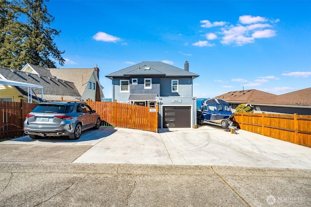 3012 N 30th St, Tacoma, WA 98407 - view of front of home featuring stucco siding, a garage, fence, and a chimney