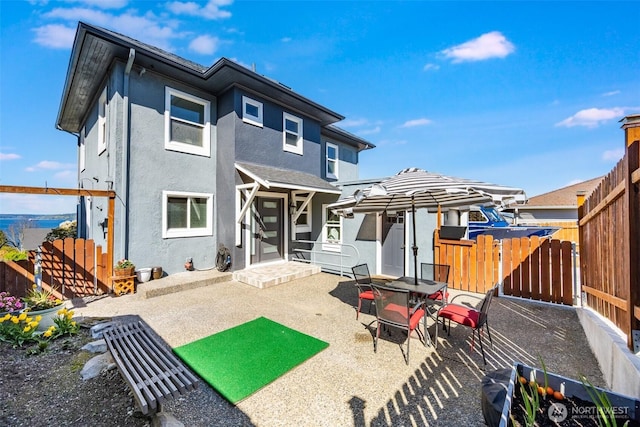 3012 N 30th St, Tacoma, WA 98407 - back of property featuring a patio, a fenced backyard, and stucco siding