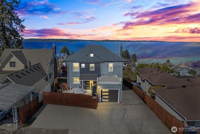 3012 N 30th St, Tacoma, WA 98407 - view of front facade featuring fence, a residential view, stucco siding, a chimney, and a water view