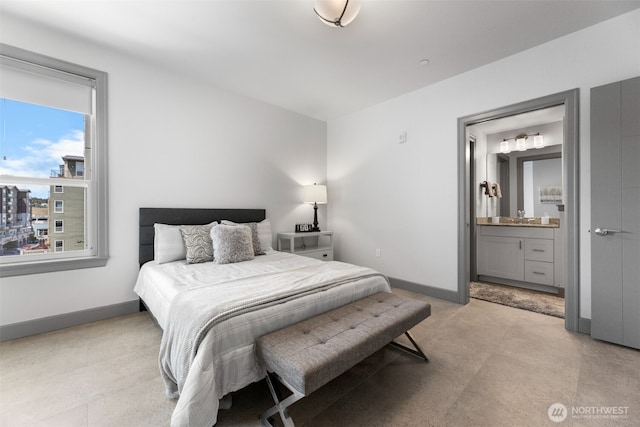 4961 Main St Unit 612, Tacoma, WA 98407 - bedroom with baseboards, ensuite bathroom, and a sink