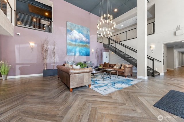 4961 Main St Unit 612, Tacoma, WA 98407 - living area featuring a towering ceiling, baseboards, stairway, a chandelier, and recessed lighting