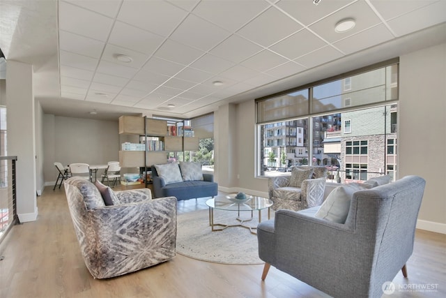 4961 Main St Unit 612, Tacoma, WA 98407 - living room with wood finished floors, baseboards, and a paneled ceiling