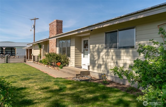177 Salmon Creek Rd, Okanogan, WA 98840 - back of house featuring a lawn, fence, and a chimney