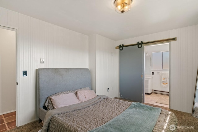 177 Salmon Creek Rd, Okanogan, WA 98840 - bedroom featuring a baseboard heating unit, a barn door, and connected bathroom