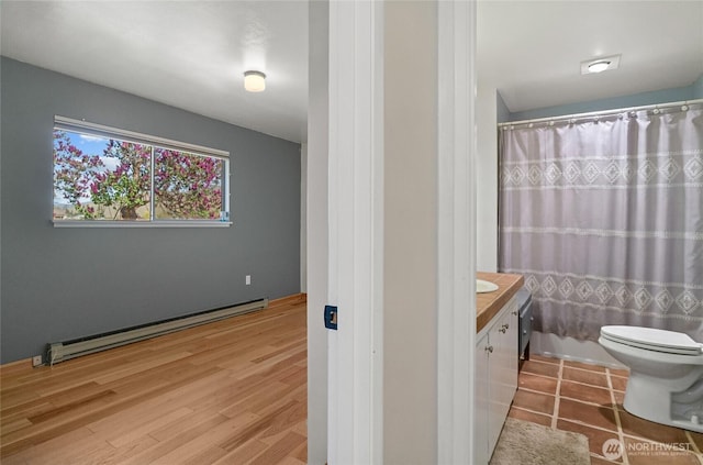 177 Salmon Creek Rd, Okanogan, WA 98840 - bathroom featuring vanity, baseboard heating, toilet, and curtained shower