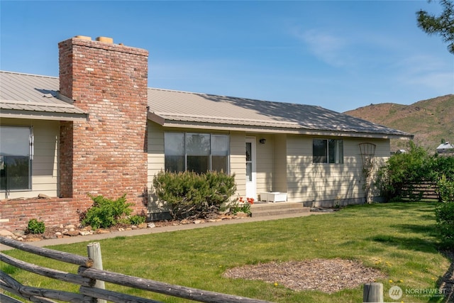 177 Salmon Creek Rd, Okanogan, WA 98840 - ranch-style home with a front lawn, fence, a chimney, and metal roof