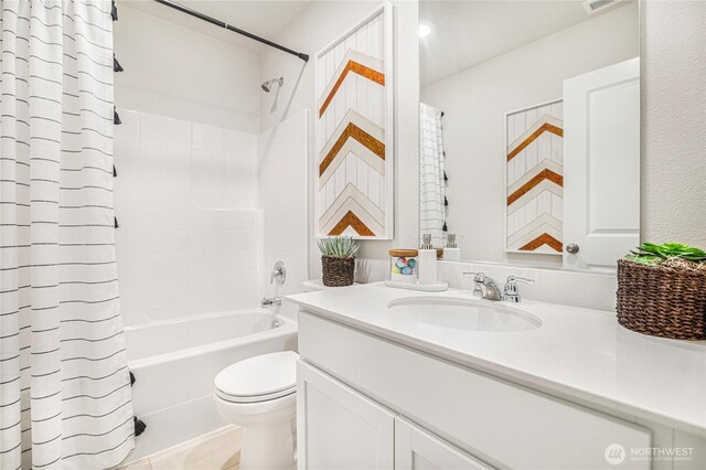 full bath with vanity, shower / bath combo, and toilet