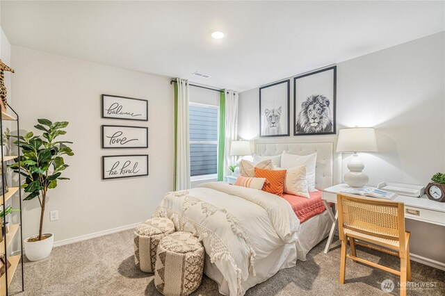 carpeted bedroom featuring baseboards and visible vents