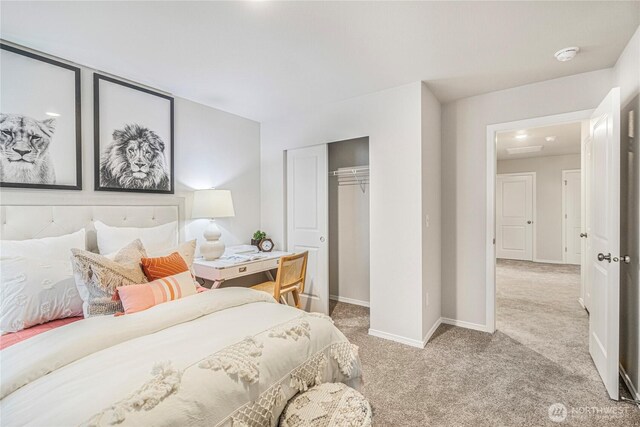 carpeted bedroom with baseboards and a closet