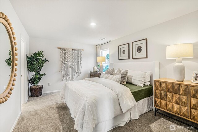bedroom with carpet floors, baseboards, and visible vents