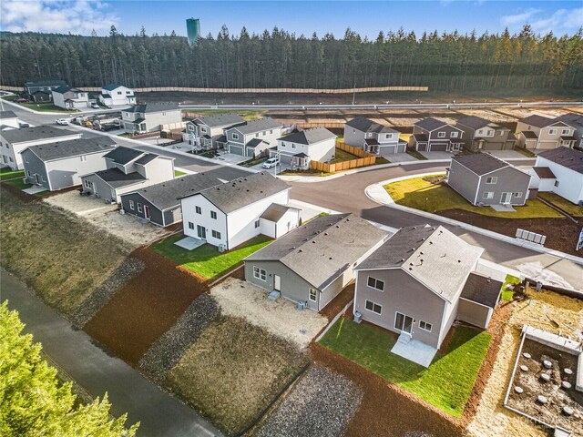 bird's eye view featuring a forest view and a residential view