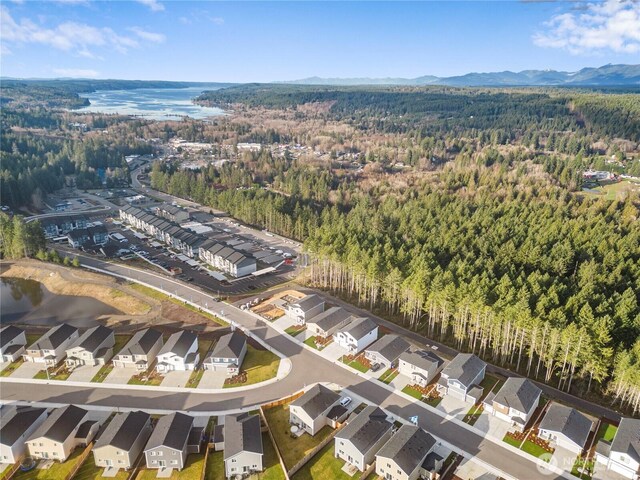 birds eye view of property with a residential view, a mountain view, and a wooded view