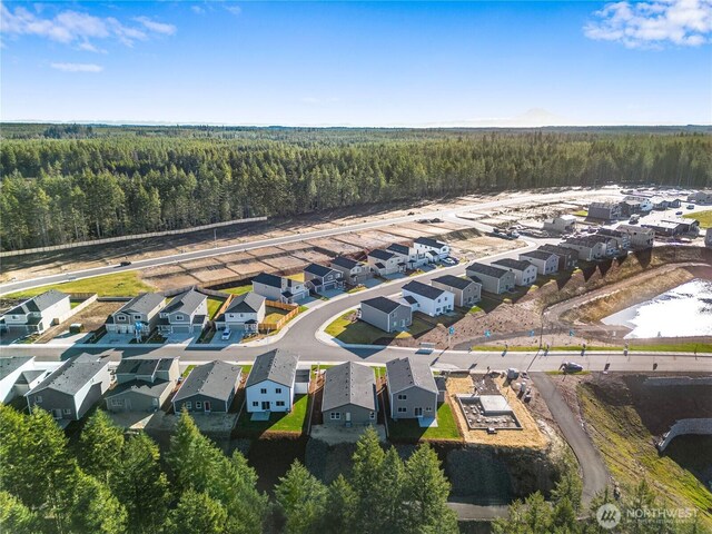 birds eye view of property with a residential view and a view of trees