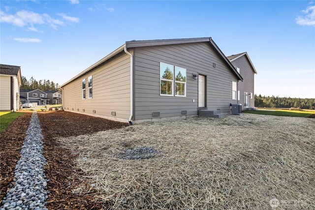 rear view of property featuring central air condition unit