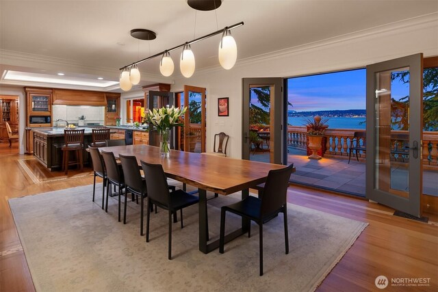dining space featuring light wood-style floors, recessed lighting, ornamental molding, and rail lighting