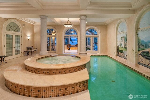 view of swimming pool with french doors, decorative columns, and a pool with connected hot tub