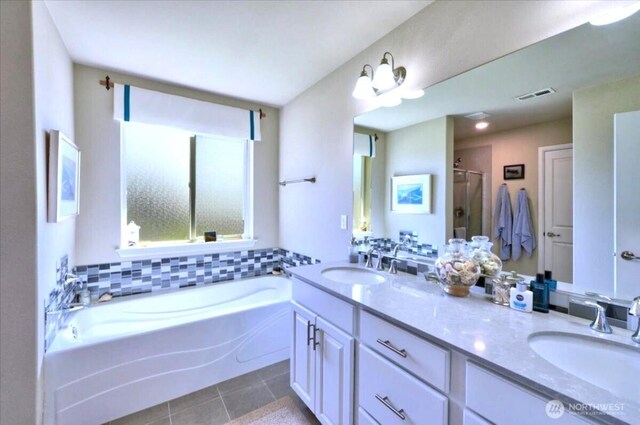 full bathroom with visible vents, a sink, tile patterned flooring, and a stall shower